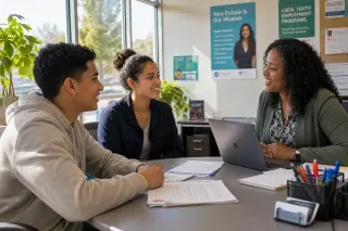 Young adults from diverse backgrounds in a bright office, actively discussing job opportunities with a supportive counselor.